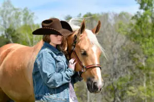 Lexi Edsall and her palomino quarter horse Shiner Surprize